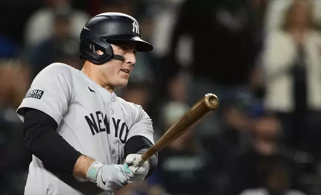 New York Yankees' Anthony Rizzo follows through on an RBI double against the Seattle Mariners during the 10th inning of a baseball game Wednesday, Sept. 18, 2024, in Seattle. (AP Photo/Lindsey Wasson)