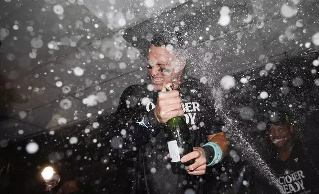 New York Yankees' Aaron Judge celebrates clinching a playoff spot after a 2-1 win in 10 innings over the Seattle Mariners in a baseball game Wednesday, Sept. 18, 2024, in Seattle. (AP Photo/Lindsey Wasson)