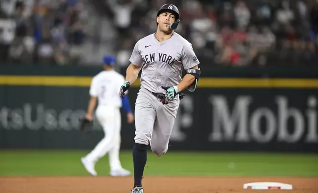 New York Yankees' Giancarlo Stanton runs the bases after hitting a solo home run in the eighth inning of a baseball game against the Texas Rangers, Monday, Sept. 2, 2024, in Arlington, Texas. (AP Photo/Albert Pena)