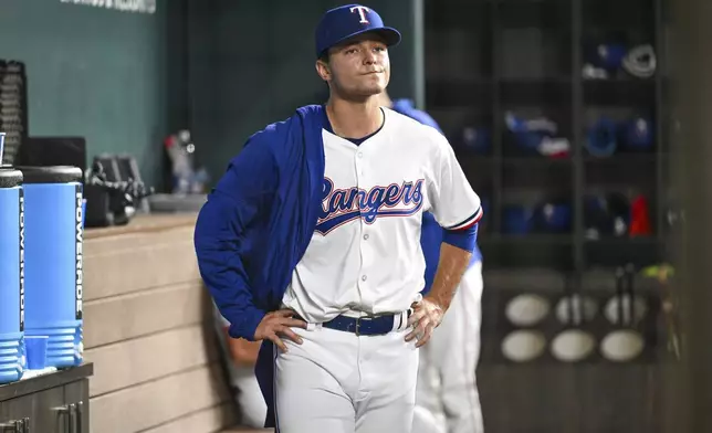 Texas Rangers starting pitcher Jack Leiter stands in the dugout after being pulled in the sixth inning of a baseball game against the New York Yankees, Monday, Sept. 2, 2024, in Arlington, Texas. (AP Photo/Albert Pena)