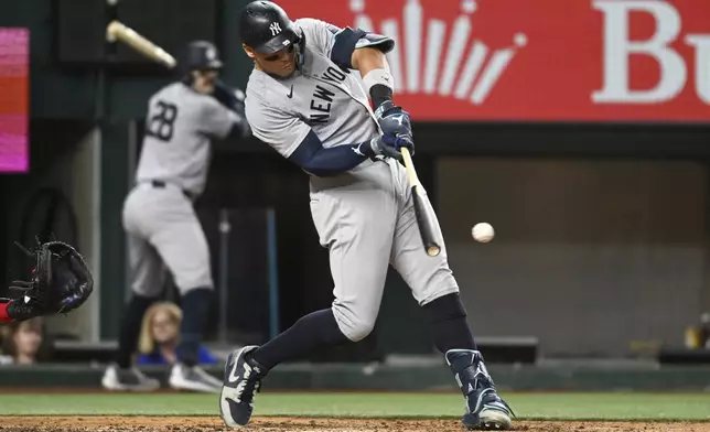 New York Yankees' Aaron Judge follows through on an RBI double in the sixth inning of a baseball game against the Texas Rangers, Monday, Sept. 2, 2024, in Arlington, Texas. (AP Photo/Albert Pena)