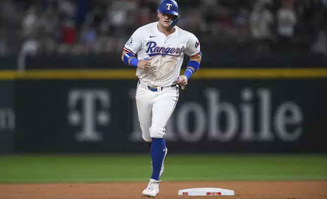 Texas Rangers' Josh Jung rounds second base on a home run hit by Wyatt Langford in the seventh inning of a baseball game against the New York Yankees, Monday, Sept. 2, 2024, in Arlington, Texas. (AP Photo/Albert Pena)