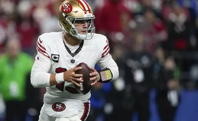 San Francisco 49ers quarterback Brock Purdy runs with the ball against the Seattle Seahawks during the second half of an NFL football game Thursday, Oct. 10, 2024 in Seattle. (AP Photo/Lindsey Wasson)