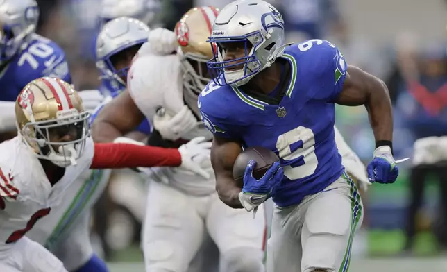 Seattle Seahawks running back Kenneth Walker III (9) runs during the first half of an NFL football game against the San Francisco 49ers, Thursday, Oct. 10, 2024, in Seattle. (AP Photo/John Froschauer)