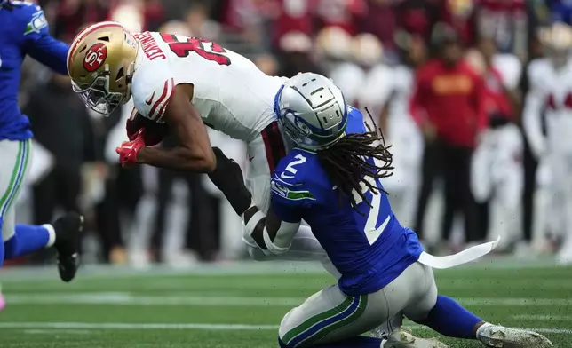 San Francisco 49ers wide receiver Jauan Jennings (15) makes a catch against Seattle Seahawks safety Rayshawn Jenkins (2) during the first half of an NFL football game, Thursday, Oct. 10, 2024, in Seattle. (AP Photo/Lindsey Wasson)