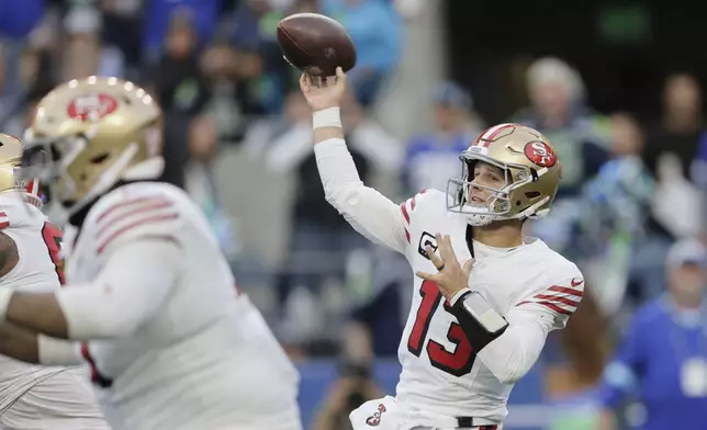 San Francisco 49ers quarterback Brock Purdy throws during the first half of an NFL football game against the Seattle Seahawks, Thursday, Oct. 10, 2024, in Seattle. (AP Photo/John Froschauer)