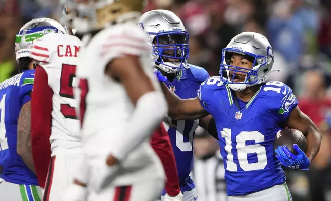 Seattle Seahawks wide receiver Tyler Lockett (16) reacts after scoring a touchdown against the San Francisco 49ers during the second half of an NFL football game Thursday, Oct. 10, 2024 in Seattle. (AP Photo/Lindsey Wasson)