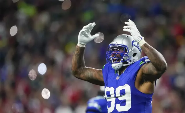 Seattle Seahawks defensive end Leonard Williams gestures to the crowd during a stoppage against the San Francisco 49ers during the second half of an NFL football game Thursday, Oct. 10, 2024 in Seattle. (AP Photo/Lindsey Wasson)