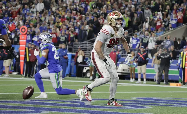 San Francisco 49ers tight end George Kittle reacts after scoring during the second half of an NFL football game against the Seattle SeahawksThursday, Oct. 10, 2024, in Seattle. (AP Photo/John Froschauer)