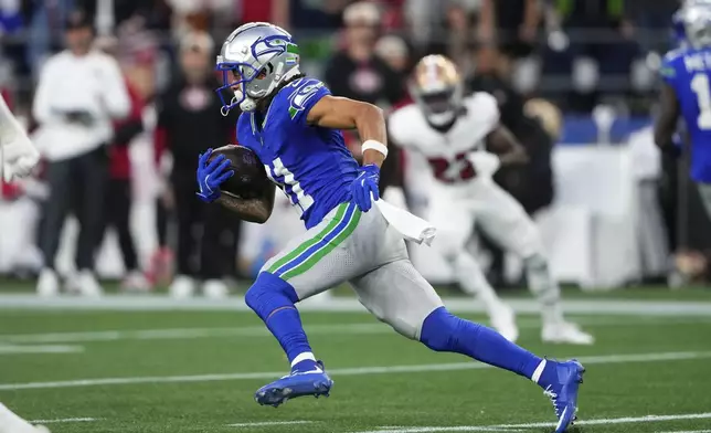 Seattle Seahawks' Jaxon Smith-Njigba runs during the first half of an NFL football game against the San Francisco 49ers, Thursday, Oct. 10, 2024, in Seattle. (AP Photo/Lindsey Wasson)