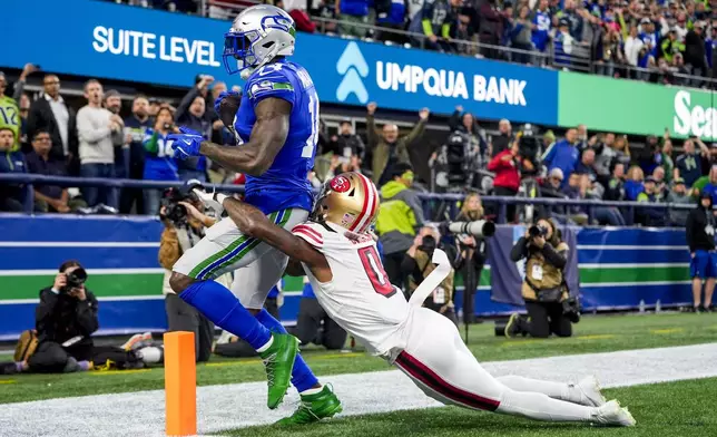 Seattle Seahawks wide receiver DK Metcalf, left, is unable to bring in a pass in the end zone against San Francisco 49ers cornerback Renardo Green, right, during the first half of an NFL football game Thursday, Oct. 10, 2024 in Seattle. (AP Photo/Lindsey Wasson)