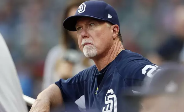 FILE - San Diego Padres bench coach Mark McGwire (25) watch from the dugout during a baseball game against the Atlanta Braves Thursday, June 14, 2018, in Atlanta. (AP Photo/John Bazemore, File)