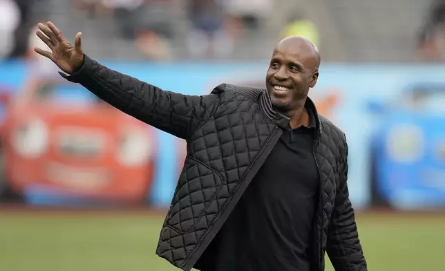 FILE - Former San Francisco Giants player Barry Bonds waves as he arrives at a ceremony honoring Hunter Pence on the team's Wall of Fame before a baseball game between the Giants and the Los Angeles Dodgers in San Francisco, Saturday, Sept. 17, 2022. (AP Photo/Jeff Chiu, File)