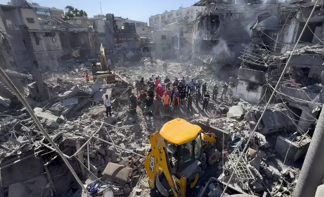 Rescue workers search for victims at the site of Israeli airstrikes that destroyed buildings facing the city's main government hospital in a densely-populated neighborhood, in southern Beirut, Lebanon, Tuesday, Oct. 22, 2024. (AP Photo/Hussein Malla)