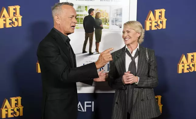 Tom Hanks, left, and Robin Wright arrive at the AFI Fest premiere of "Here" on Friday, Oct. 25, 2024, at TCL Chinese Theatre in Los Angeles. (AP Photo/Chris Pizzello)