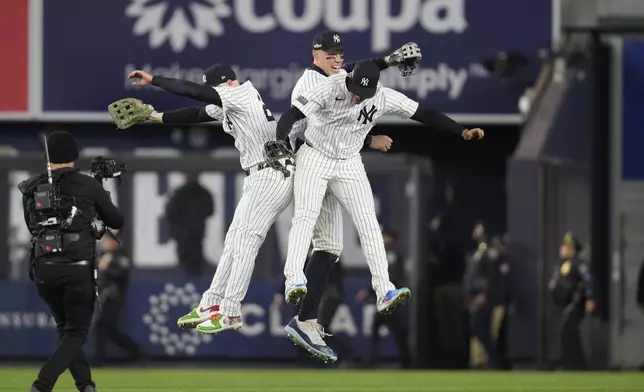 From left to right, Alex Verdugo, Aaron Judge and Juan Soto celebrate after Game 1 of the baseball AL Championship Series against the Cleveland Guardians Monday, Oct. 14, 2024, in New York. The Yankees won 5-2. (AP Photo/Godofredo Vásquez)