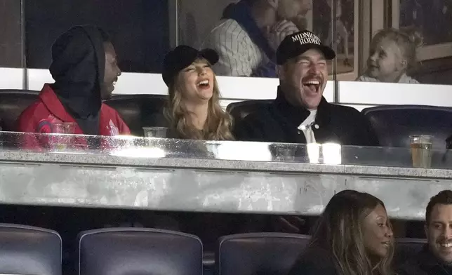 Travis Kelce, right, and Taylor Swift attend Game 1 of the baseball AL Championship Series between the Cleveland Guardians and New York Yankees Monday, Oct. 14, 2024, in New York. (AP Photo/Seth Wenig)