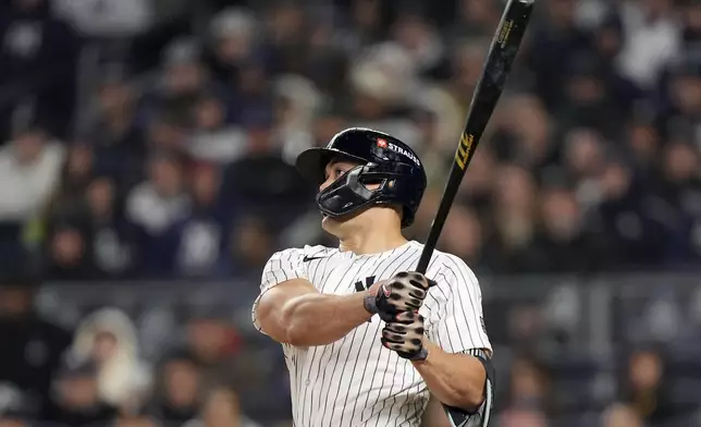 New York Yankees' Giancarlo Stanton watches his home run against the Cleveland Guardians during the seventh inning in Game 1 of the baseball AL Championship Series Monday, Oct. 14, 2024, in New York. (AP Photo/Frank Franklin II)