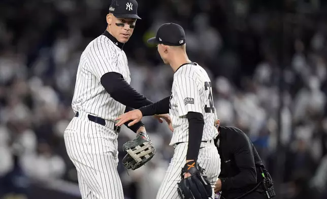 New York Yankees' Aaron Judge, left, celebrates with Luke Weaver after Game 2 of the baseball AL Championship Series against the Cleveland Guardians Tuesday, Oct. 15, 2024, in New York. The Yankees won 6-3. (AP Photo/Frank Franklin II)