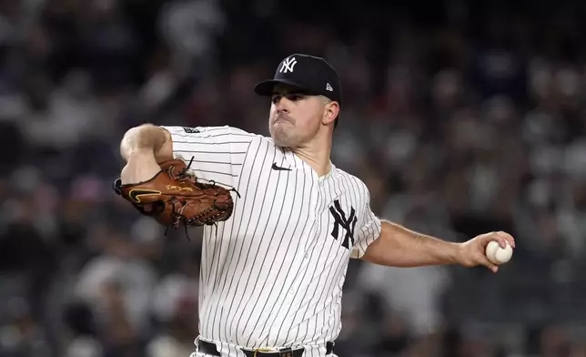 New York Yankees starting pitcher Carlos Rodón throws during the first inning in Game 1 of the baseball AL Championship Series against the Cleveland Guardians Monday, Oct. 14, 2024, in New York. (AP Photo/Godofredo Vásquez)