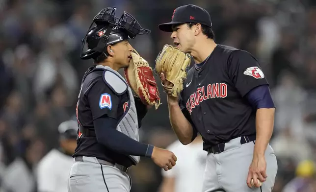 Cleveland Guardians pitcher Joey Cantillo, right, talks with catcher Bo Naylor during the third inning in Game 1 of the baseball AL Championship Series against the New York Yankees Monday, Oct. 14, 2024, in New York. (AP Photo/Godofredo Vásquez)