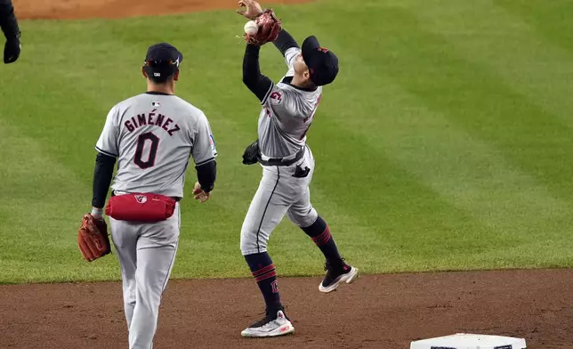 Cleveland Guardians shortstop Brayan Rocchio misses catching a pop fly by New York Yankees' Aaron Judge during the first inning in Game 2 of the baseball AL Championship Series Tuesday, Oct. 15, 2024, in New York. Rocchio was charged with an error. (AP Photo/Seth Wenig)