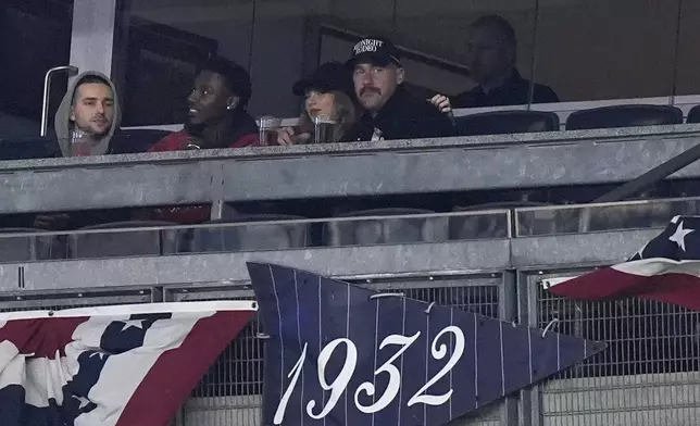 Travis Kelce and Taylor Swift watch Game 1 of the baseball AL Championship Series between the Cleveland Guardians and New York Yankees Monday, Oct. 14, 2024, in New York. (AP Photo/Frank Franklin II)