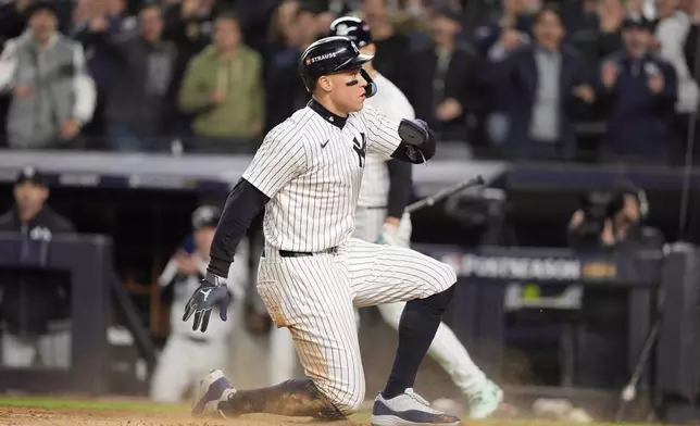 New York Yankees' Aaron Judge scores on a wild pitch by Cleveland Guardians pitcher Joey Cantillo during the third inning in Game 1 of the baseball AL Championship Series Monday, Oct. 14, 2024, in New York. (AP Photo/Frank Franklin II)