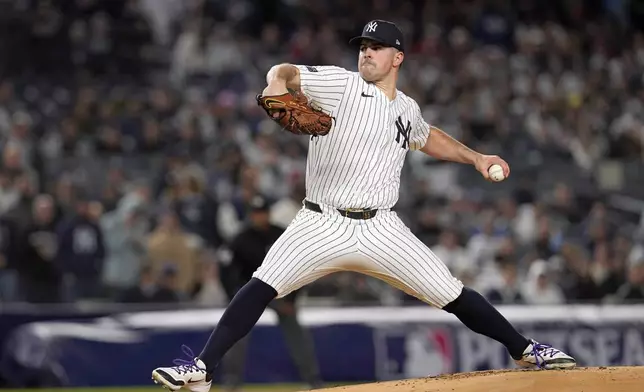 New York Yankees starting pitcher Carlos Rodón throws during the first inning in Game 1 of the baseball AL Championship Series against the Cleveland Guardians Monday, Oct. 14, 2024, in New York. (AP Photo/Godofredo Vásquez)