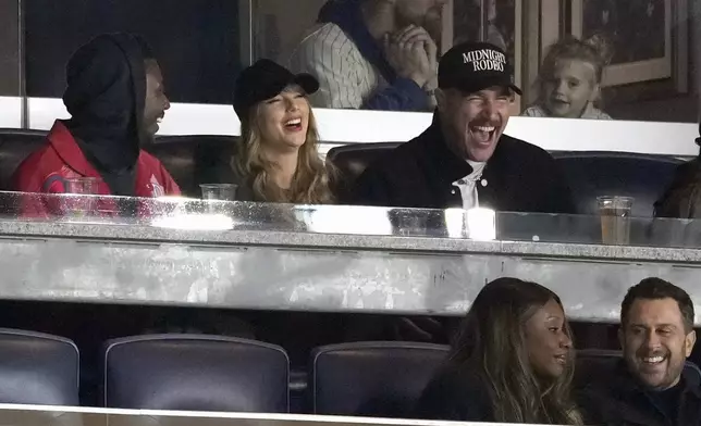 Travis Kelce, right, and Taylor Swift attend Game 1 of the baseball AL Championship Series between the Cleveland Guardians and New York Yankees Monday, Oct. 14, 2024, in New York. (AP Photo/Seth Wenig)