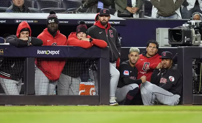 Cleveland Guardians players watch from the dugout during the ninth inning in Game 1 of the baseball AL Championship Series against the New York Yankees Monday, Oct. 14, 2024, in New York. (AP Photo/Godofredo Vásquez)