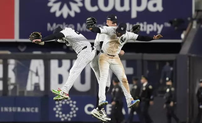 New York Yankees' Alex Verdugo, Aaron Judge and Juan Soto celebrate after Game 2 of the baseball AL Championship Series against the Cleveland Guardians Tuesday, Oct. 15, 2024, in New York. The Yankees won 6-3. (AP Photo/Godofredo Vásquez)