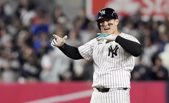 New York Yankees' Anthony Rizzo celebrates after hitting a RBI double against the Cleveland Guardians during the sixth inning in Game 2 of the baseball AL Championship Series Tuesday, Oct. 15, 2024, in New York. (AP Photo/Godofredo Vásquez)