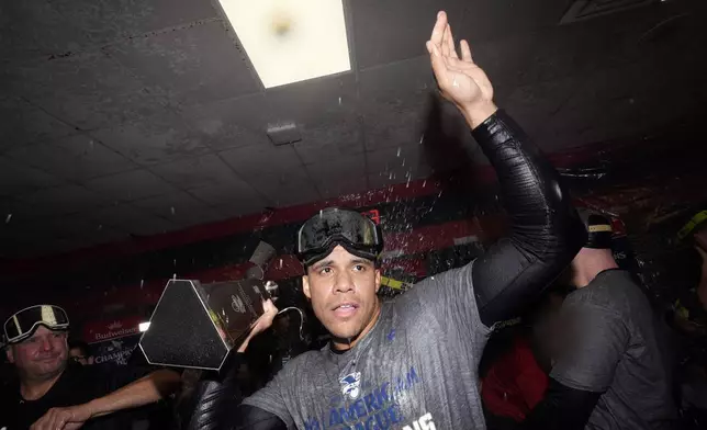 New York Yankees' Juan Soto celebrates in the clubhouse after Game 5 of the baseball AL Championship Series against the Cleveland Guardians Sunday, Oct. 20, 2024, in Cleveland. The Yankees won 5-2 to advance to the World Series. (AP Photo/Godofredo A. Vásquez )