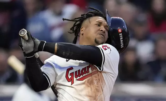 Cleveland Guardians' José Ramírez loses his helmet as he swings for a strike against the New York Yankees during the fifth inning in Game 3 of the baseball AL Championship Series Thursday, Oct. 17, 2024, in Cleveland.(AP Photo/Godofredo Vásquez )