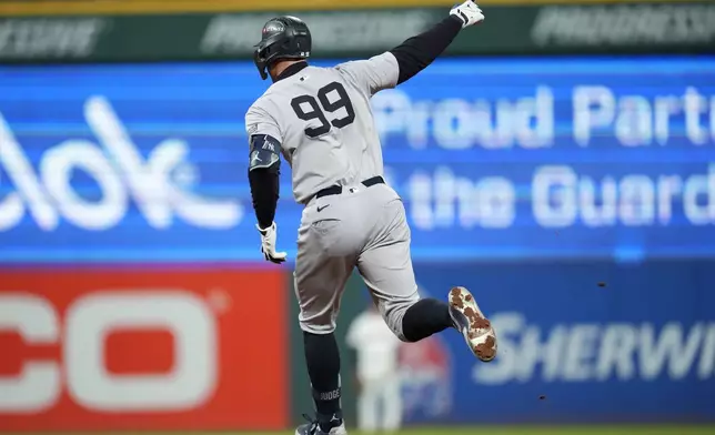 New York Yankees' Aaron Judge celebrates after hitting a two-run home run against the Cleveland Guardians during the eighth inning in Game 3 of the baseball AL Championship Series Thursday, Oct. 17, 2024, in Cleveland.(AP Photo/Godofredo Vásquez )