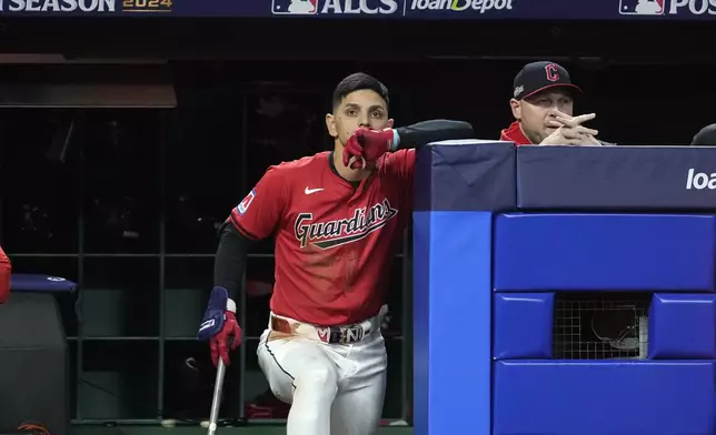 Cleveland Guardians' Andrés Giménez watches from the dugout during the sixth inning in Game 5 of the baseball AL Championship Series against the New York Yankees Saturday, Oct. 19, 2024, in Cleveland. (AP Photo/Godofredo A. Vásquez)