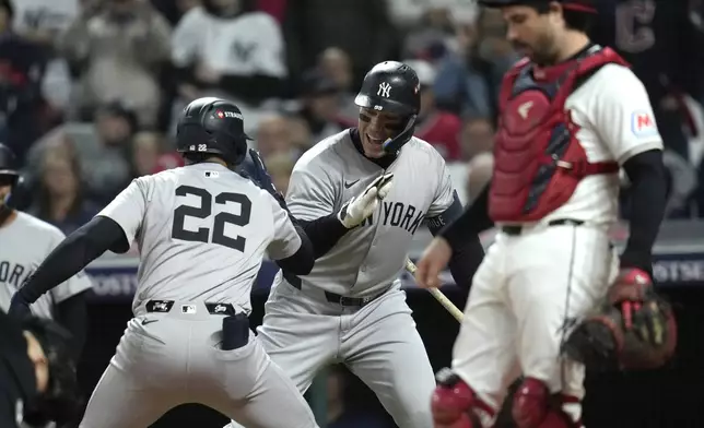 New York Yankees' Juan Soto (22) celebrates with Aaron Judge after hitting a two-run home run against the Cleveland Guardians during the first inning in Game 4 of the baseball AL Championship Series Friday, Oct. 18, 2024, in Cleveland. (AP Photo/Sue Ogrocki)