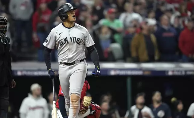 New York Yankees' Juan Soto watches his three-run home run against the Cleveland Guardians during the 10th inning in Game 5 of the baseball AL Championship Series Saturday, Oct. 19, 2024, in Cleveland. (AP Photo/Godofredo A. Vásquez)