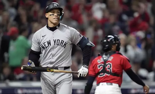 New York Yankees' Aaron Judge walks back toward the dugout after striking out against the Cleveland Guardians during the third inning in Game 5 of the baseball AL Championship Series Saturday, Oct. 19, 2024, in Cleveland. (AP Photo/Godofredo A. Vásquez)