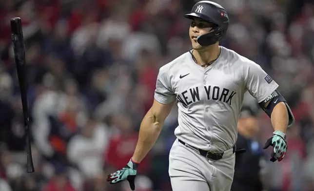 New York Yankees' Giancarlo Stanton tosses his bat after hitting a three-run home run against the Cleveland Guardians during the sixth inning in Game 4 of the baseball AL Championship Series Friday, Oct. 18, 2024, in Cleveland. (AP Photo/Godofredo A. Vásquez)