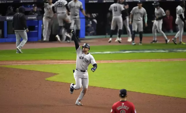 New York Yankees' Juan Soto celebrates after hitting a three-run home run against the Cleveland Guardians during the 10th inning in Game 5 of the baseball AL Championship Series Saturday, Oct. 19, 2024, in Cleveland. (AP Photo/Jeff Roberson)