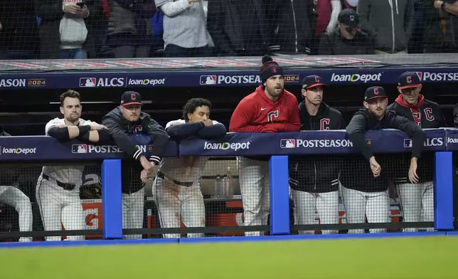 Cleveland Guardians players watch from the dugout during the ninth inning in Game 4 of the baseball AL Championship Series against the New York Yankees Friday, Oct. 18, 2024, in Cleveland. The Yankees won 8-6. (AP Photo/Godofredo A. Vásquez)