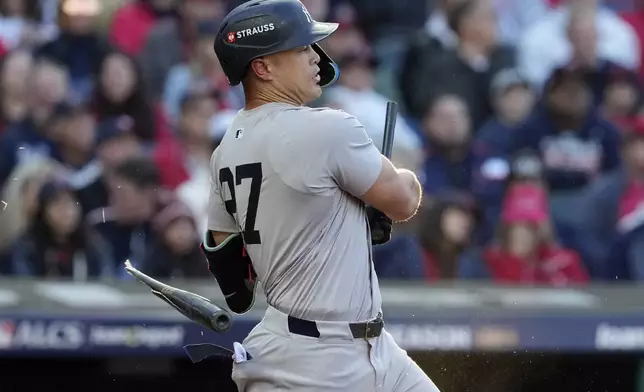 New York Yankees' Giancarlo Stanton breaks his bat hitting a ground out against the Cleveland Guardians during the third inning in Game 3 of the baseball AL Championship Series Thursday, Oct. 17, 2024, in Cleveland.(AP Photo/Godofredo Vásquez )