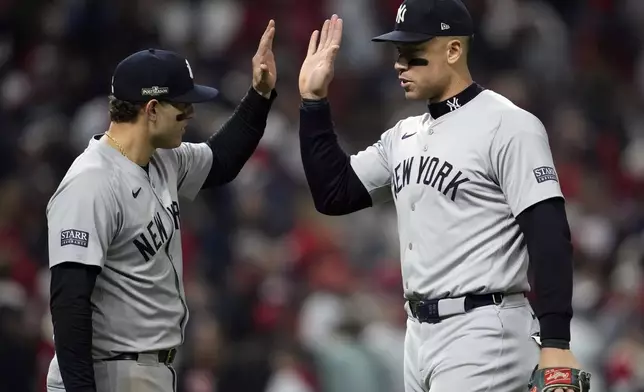 New York Yankees' Aaron Judge, right, and Anthony Rizzo celebrate after Game 4 of the baseball AL Championship Series against the Cleveland Guardians Friday, Oct. 18, 2024, in Cleveland. The Yankees won 8-6 to take a 3-1 lead in the best-of-seven series. (AP Photo/Godofredo A. Vásquez)