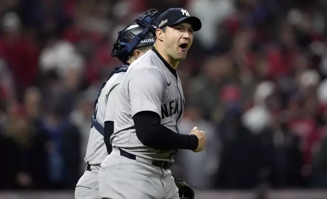 New York Yankees pitcher Tommy Kahnle celebrates after Game 4 of the baseball AL Championship Series against the Cleveland Guardians Friday, Oct. 18, 2024, in Cleveland. The Yankees won 8-6 to take a 3-1 lead in the best-of-seven series. (AP Photo/Godofredo A. Vásquez)