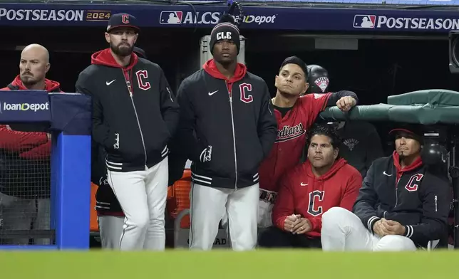 Cleveland Guardians players watch from the dugout during the 10th inning against the New York Yankees in Game 5 of the baseball AL Championship Series Saturday, Oct. 19, 2024, in Cleveland. The Yankees won 5-2. (AP Photo/Godofredo A. Vásquez)