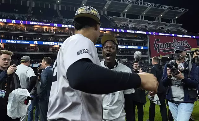 New York Yankees' Jazz Chisholm Jr., right, and Juan Soto celebrate after Game 5 of the baseball AL Championship Series against the Cleveland Guardians Saturday, Oct. 19, 2024, in Cleveland. (AP Photo/Godofredo A. Vásquez )