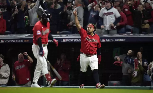 Cleveland Guardians' Josh Naylor celebrates after scoring on a RBI double by his brother, Bo Naylor, during the second inning in Game 5 of the baseball AL Championship Series against the New York Yankees Saturday, Oct. 19, 2024, in Cleveland. (AP Photo/Sue Ogrocki)