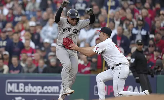 New York Yankees' Jose Trevino, left, is tagged out by Cleveland Guardians starting pitcher Matthew Boyd during the second inning in Game 3 of the baseball AL Championship Series Thursday, Oct. 17, 2024, in Cleveland.(AP Photo/Jeff Roberson)